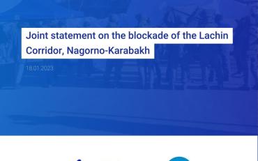 "Joint statement by the International Disability Alliance and European Disability Forum regarding the blockade of the Lachin Corridor, Nagorno-Karabakh". The text is set against a blue background. In the background, you can barely make out a photo of the 