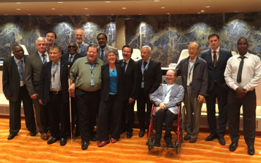 CRPD Committee members stand in the conference room at the UN in Geneva on the last day of the 18th CRPD Session
