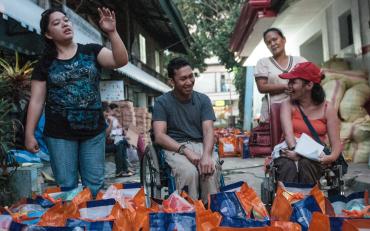 Persons with disabilities in the Philippines helping with disaster preparations.